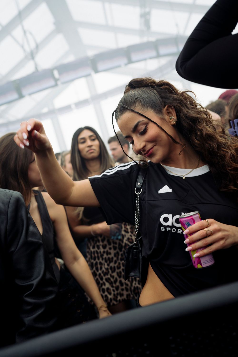 Crowd of dancers enjoying music at an indoor event.