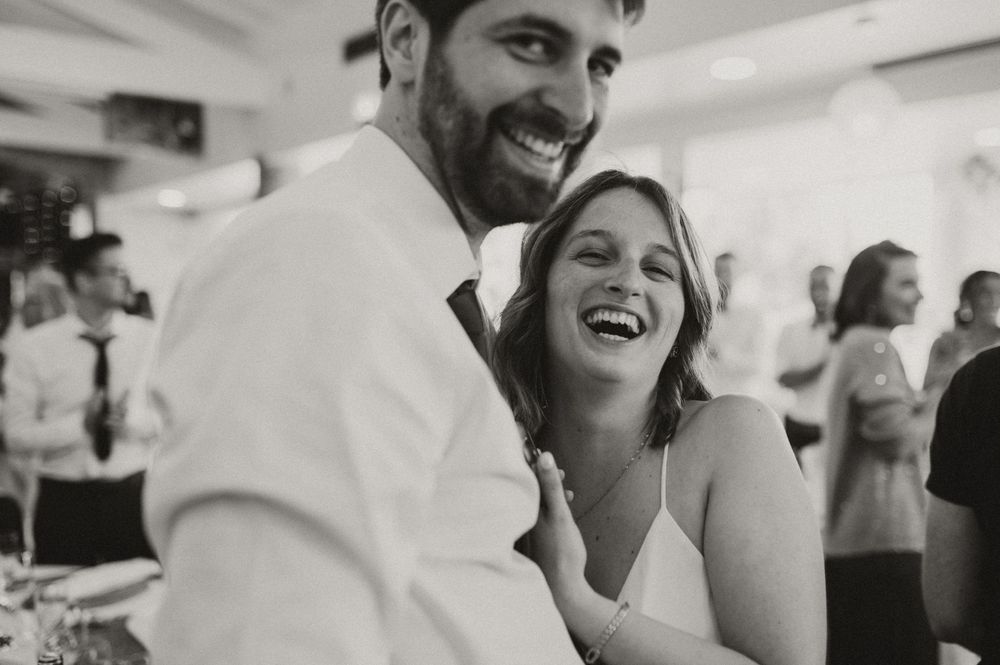 Black and white candid moment at wedding reception.