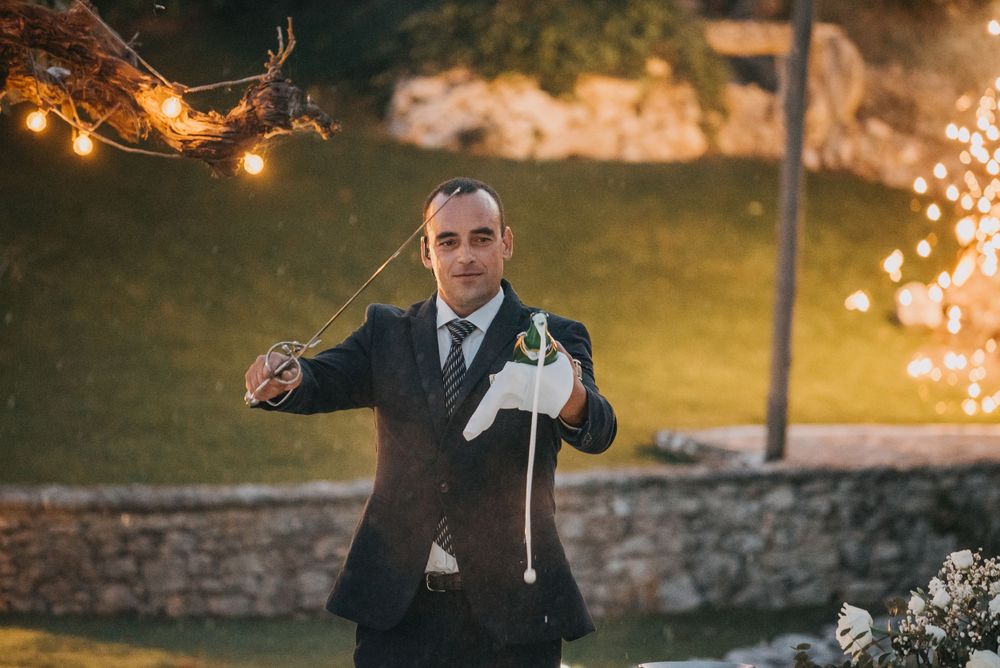 Evening wedding celebration with sparklers and romantic lighting in an outdoor setting.