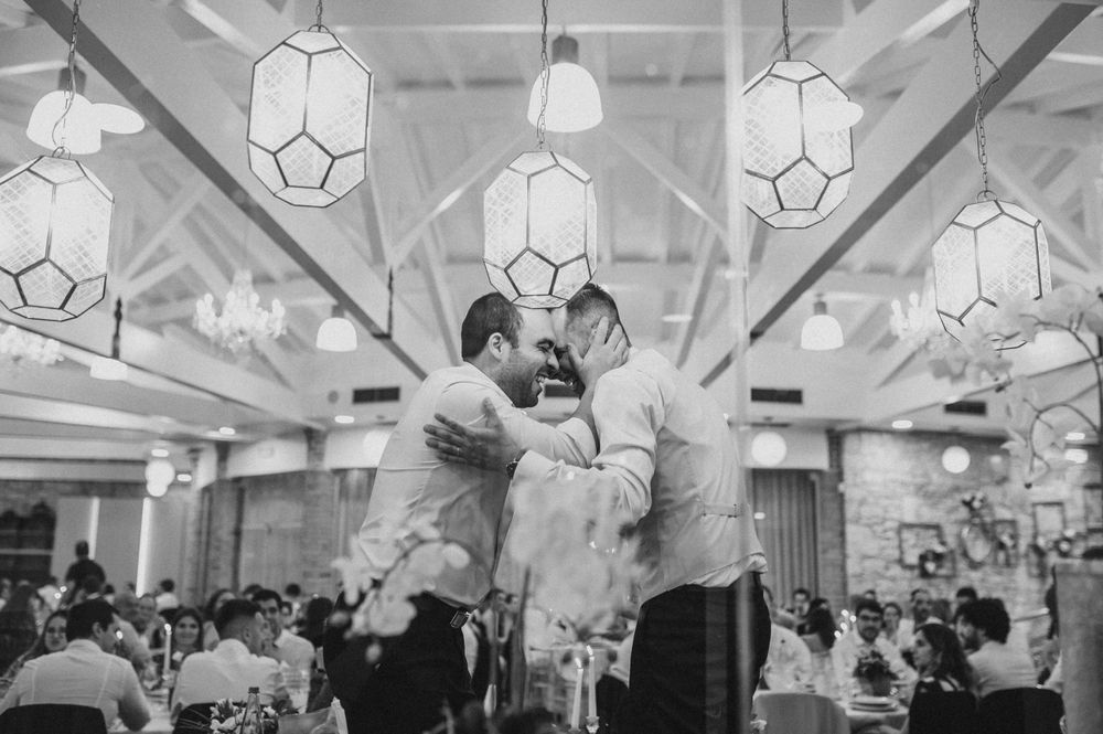 Black and white dance scene with geometric pendant lights hanging from the ceiling.