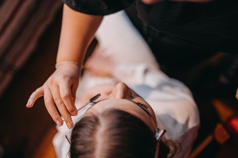 Close-up of someone receiving professional hair styling service.