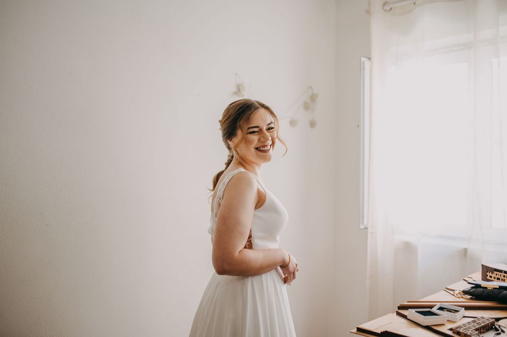 Candid moment during wedding preparations in a sun-lit room.