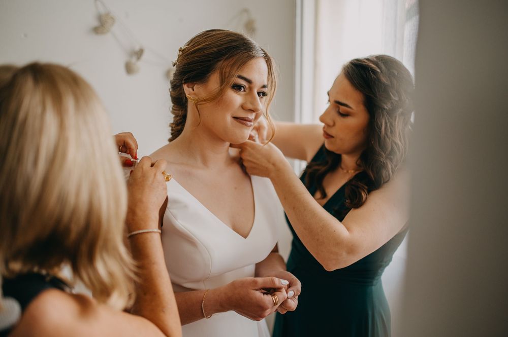 Wedding preparation scene with elegant dress and gentle styling touches.