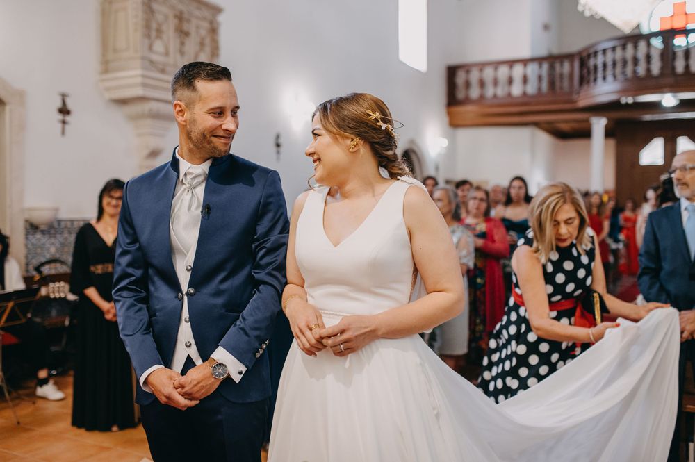 Joyful wedding ceremony moment in a traditional church with wooden interior details.