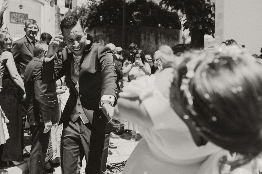 A black and white photograph capturing celebration moments at an outdoor event.