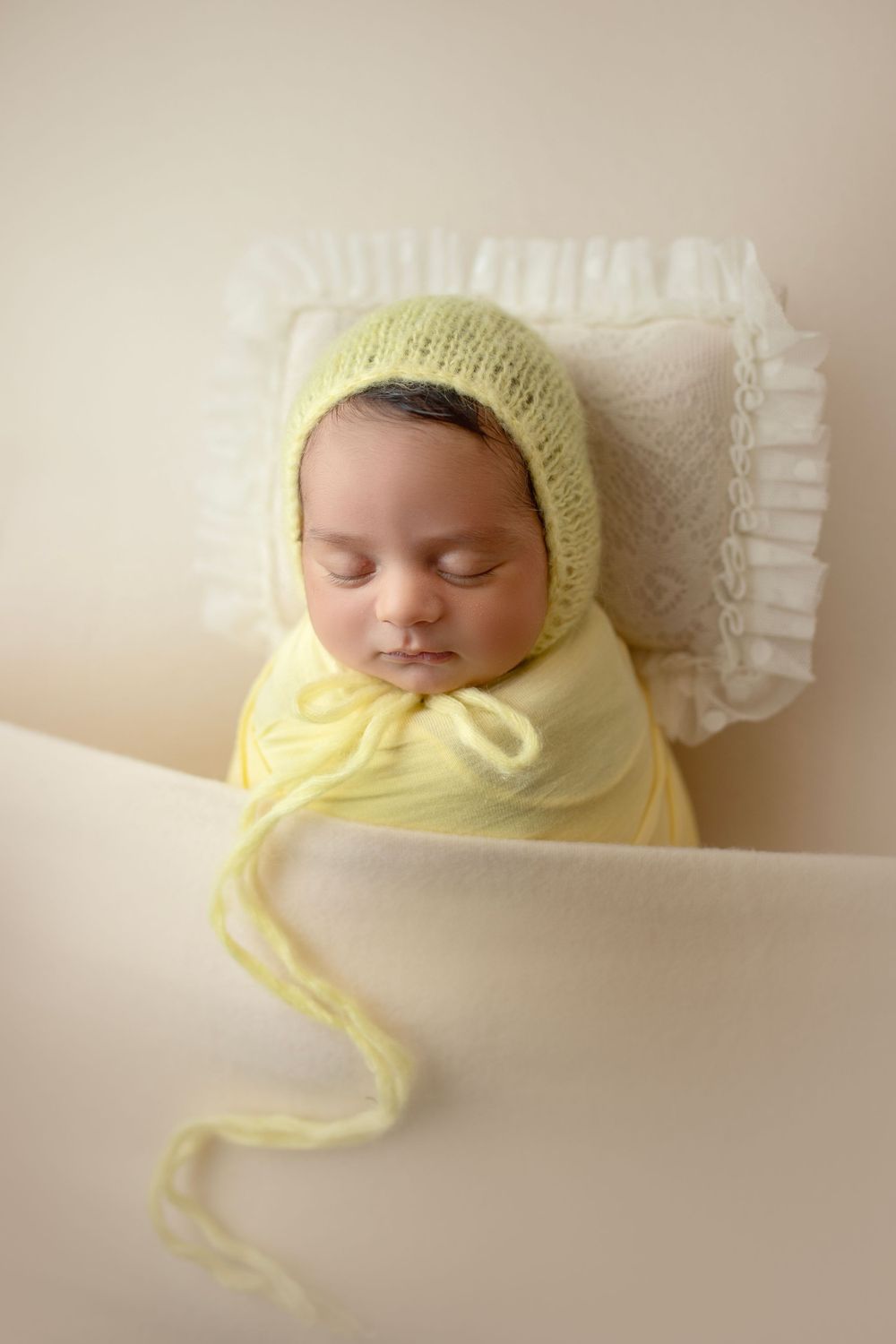 "Adorable newborn baby swaddled in prop peacefully sleeping. captured by a female photographer in Doha, qatar