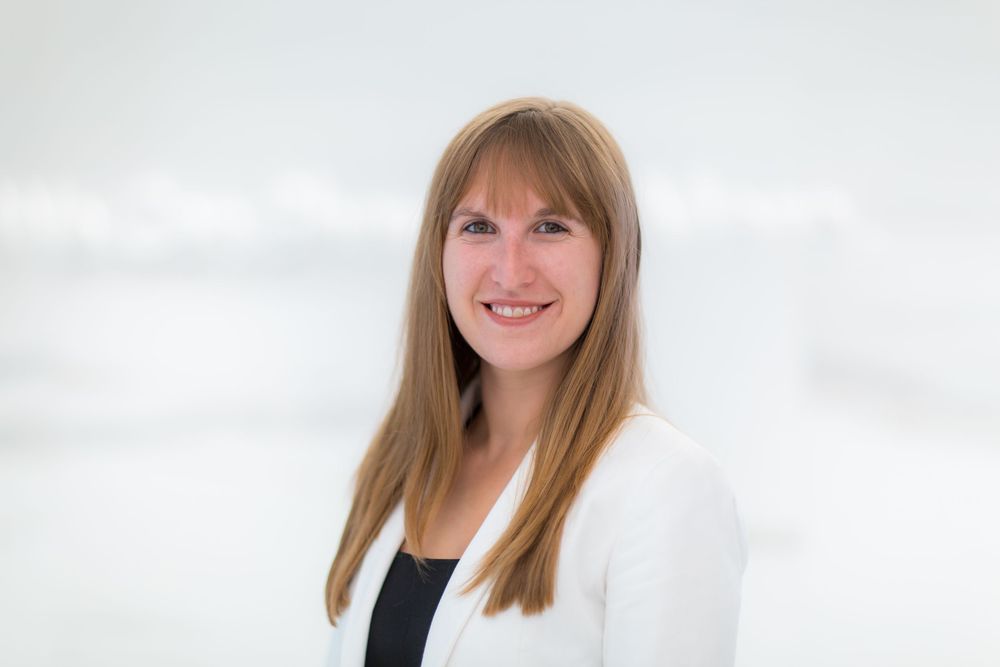 Natural light business headshot of a woman against white backdrop in Phoenix