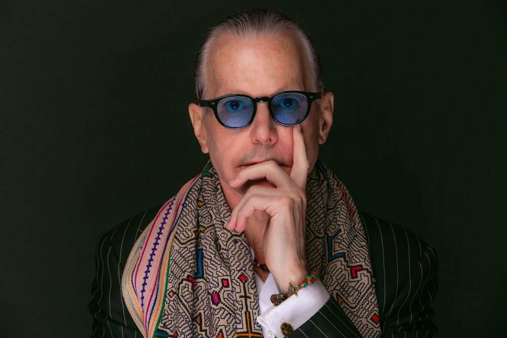business owner stands for portrait against black backdrop at a studio in Scottsdale, AZ