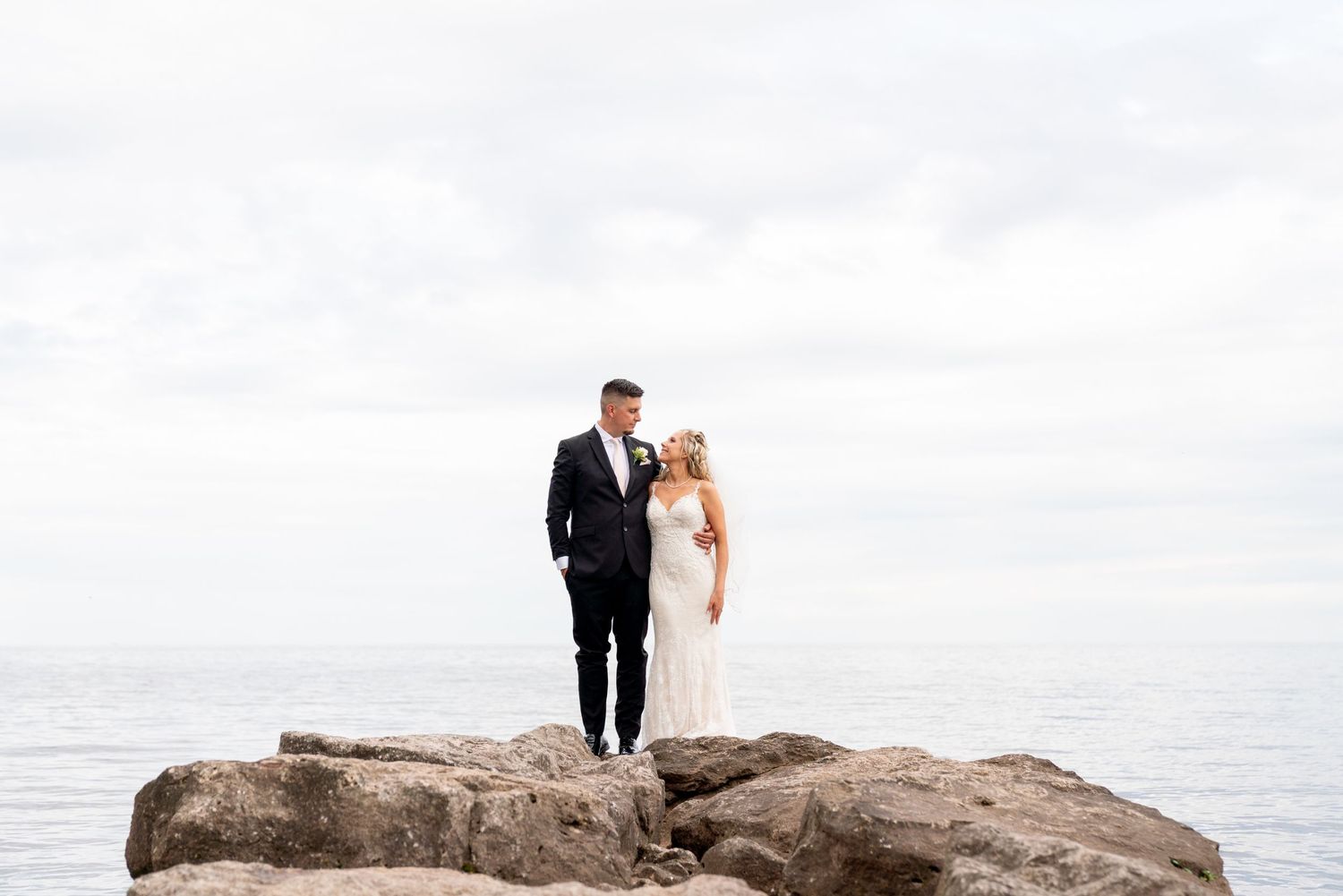Paletta Mansion wedding photo in Burlington. Couple Photography at the lake on the rocks in a lakefront venue