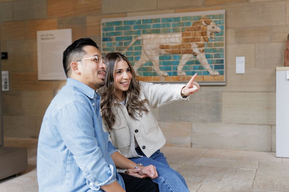 A couple in a sitting pose  at the Yale University Art Gallery. An engagement session at the museum.