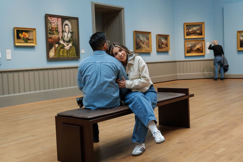 A couple in a sitting pose  at the Yale University Art Gallery. An engagement session at the museum.