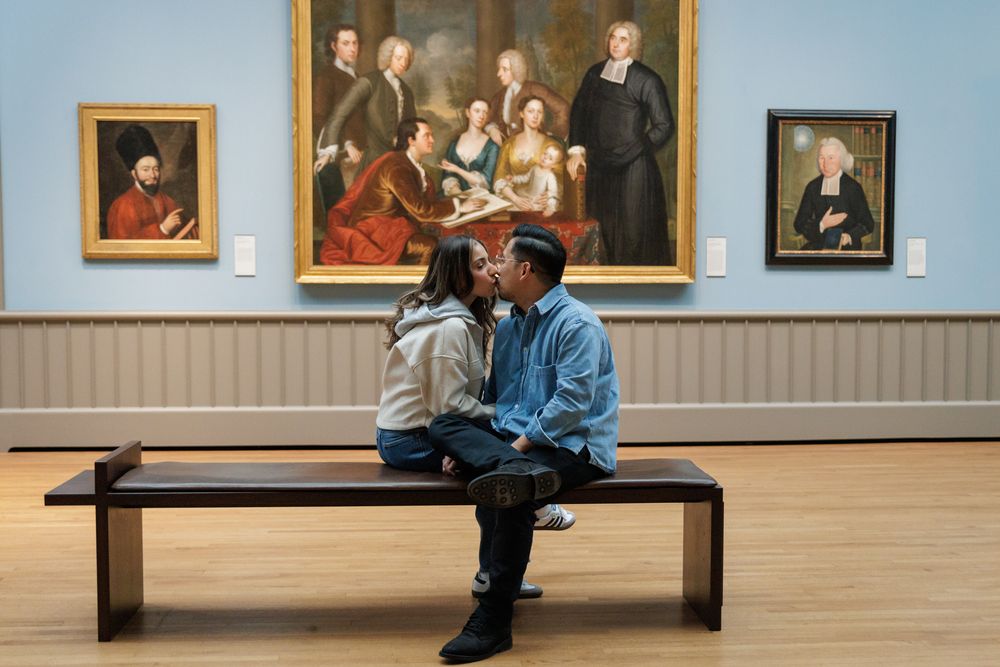 A couple in a sitting pose  at the Yale University Art Gallery. An engagement session at the museum.