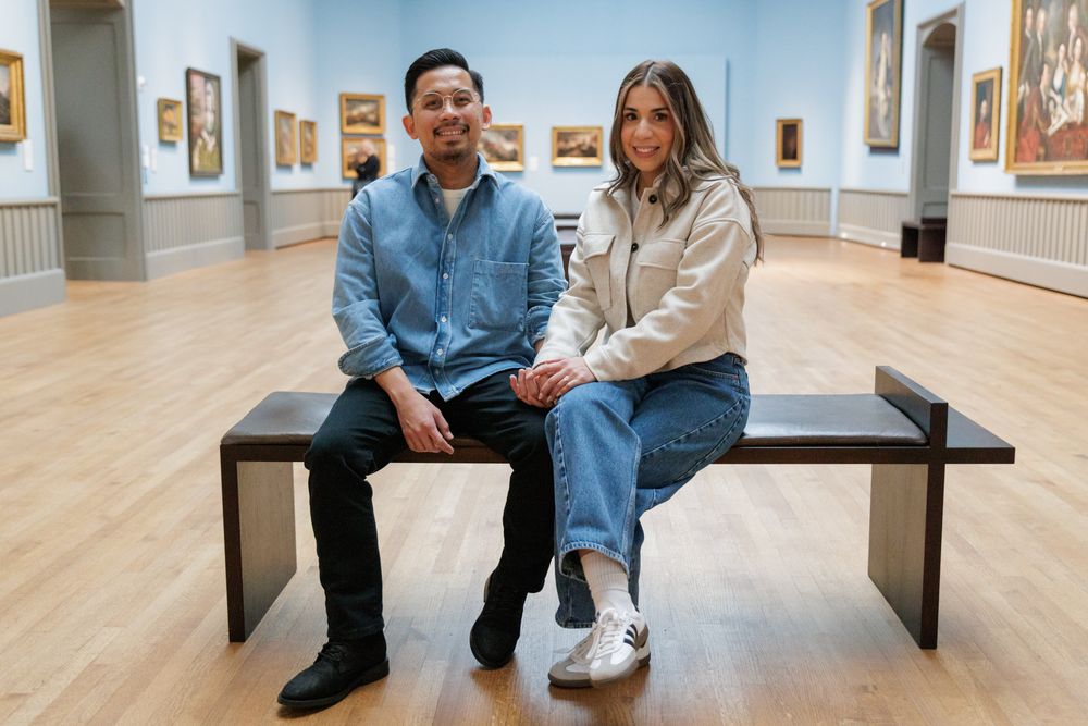 A couple in a sitting pose  at the Yale University Art Gallery. An engagement session at the museum.