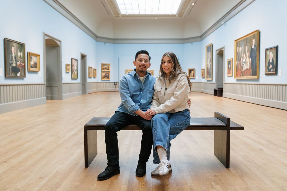 A couple in a sitting pose  at the Yale University Art Gallery. An engagement session at the museum.