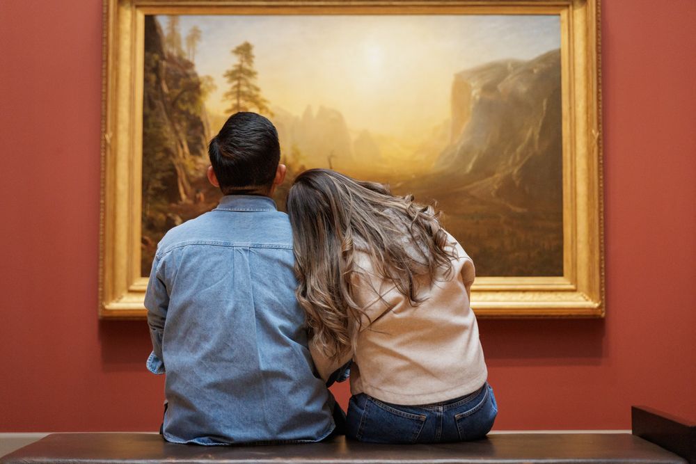 A couple in a sitting pose  at the Yale University Art Gallery. An engagement session at the museum.