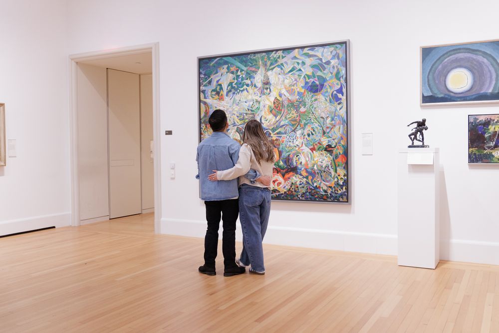 A couple looking at a blue tone painting at the Yale University Art Gallery. An engagement session at the museum.