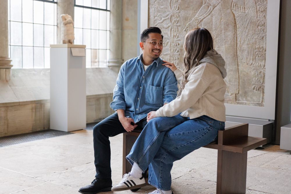 A couple in a sitting pose  at the Yale University Art Gallery. An engagement session at the museum.