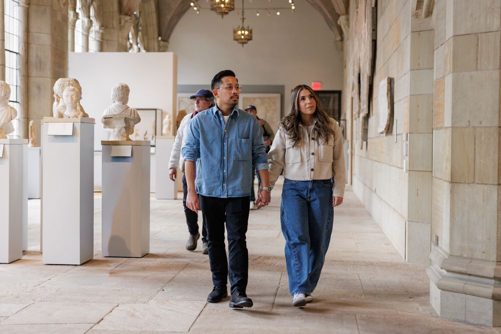 A couple walking through  at the Yale University Art Gallery. An engagement session at the museum.