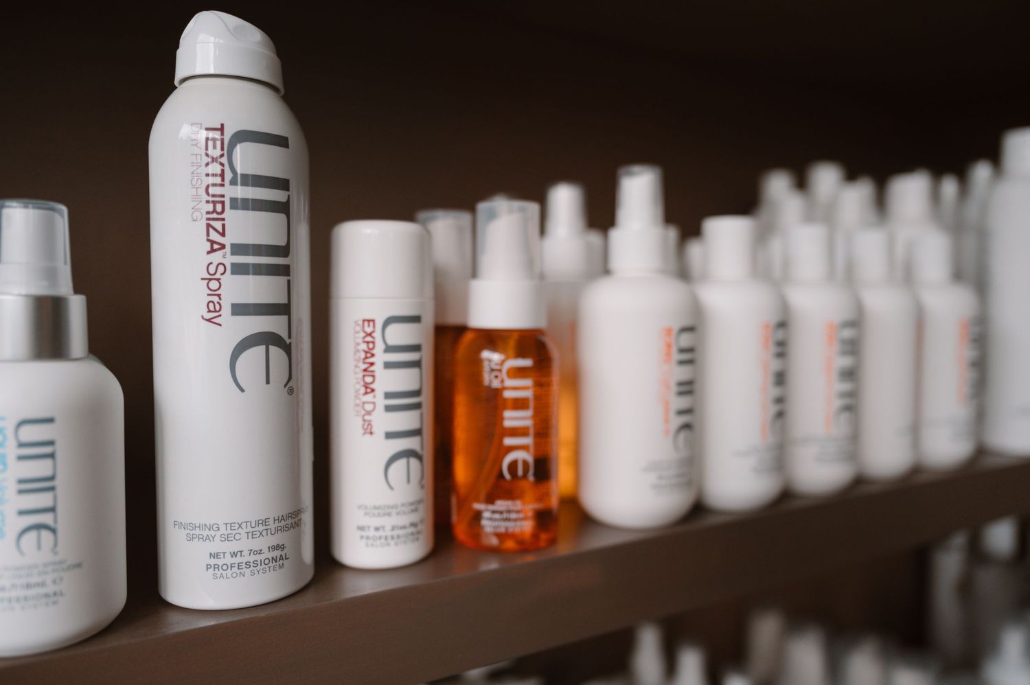 Professional hair care products from Unite brand arranged on retail display shelf.