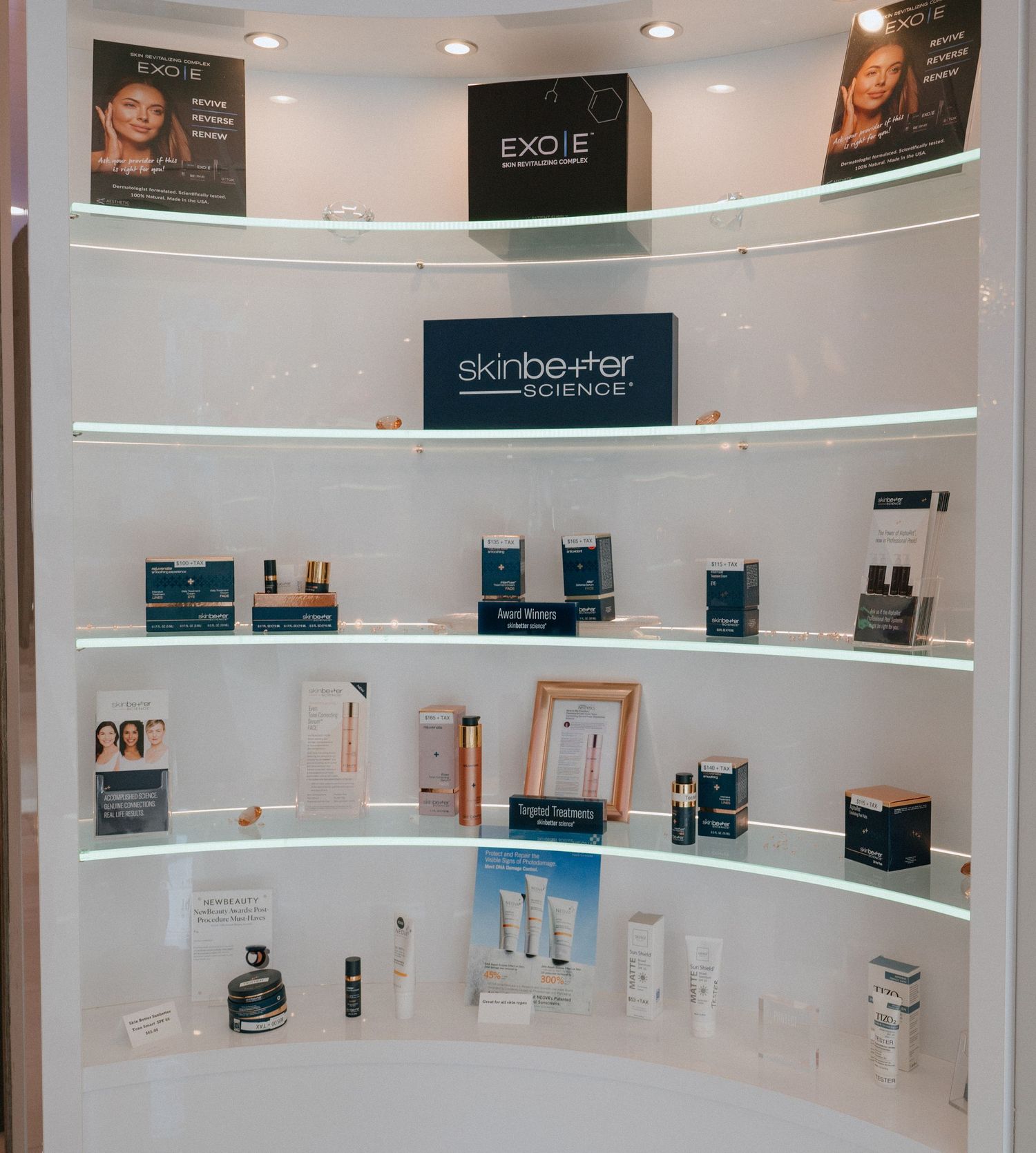 Curved retail display wall featuring Skinbetter and other professional skincare product lines.