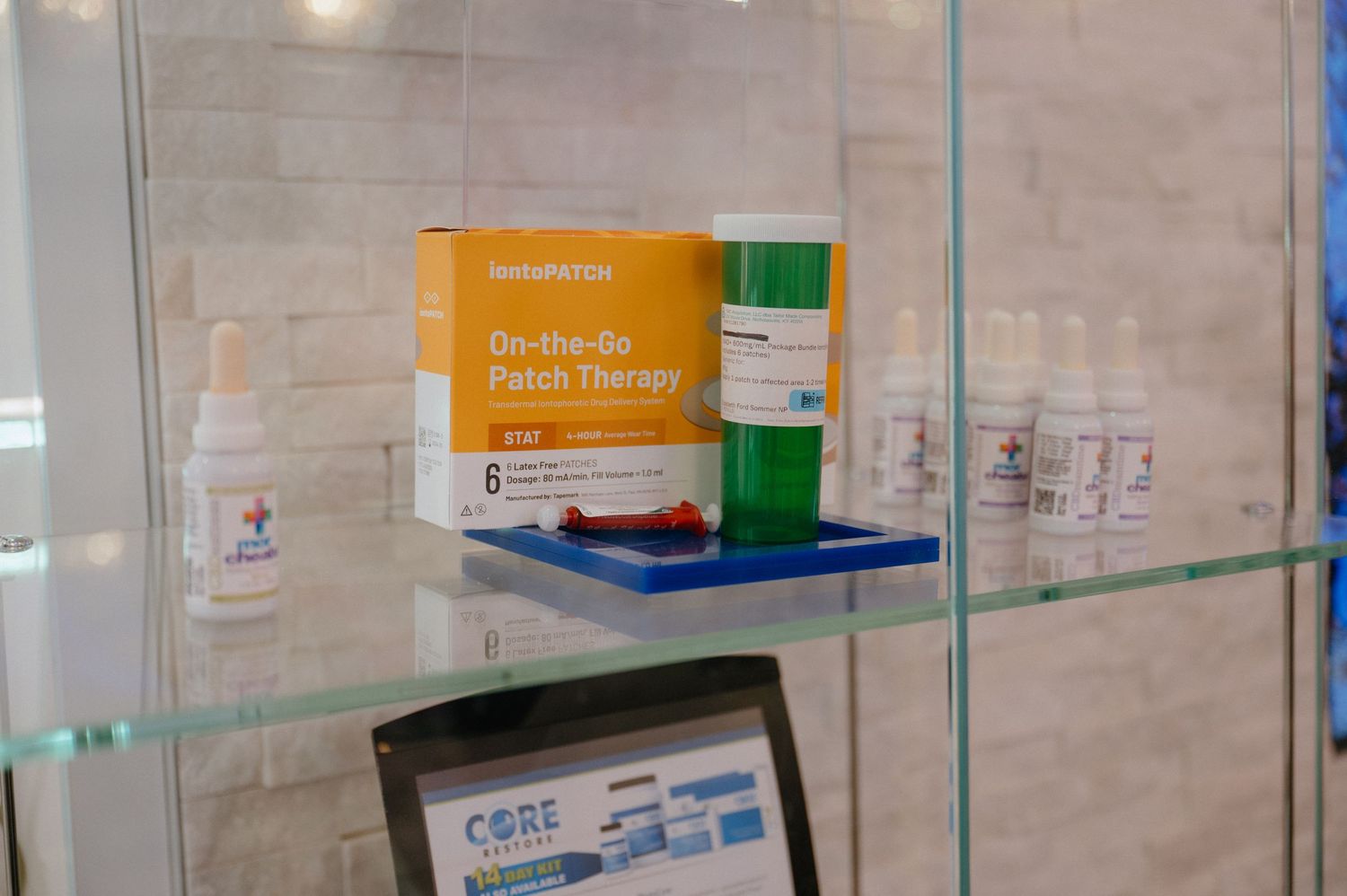 Close-up of medical-grade skincare products displayed on glass shelving in spa setting.
