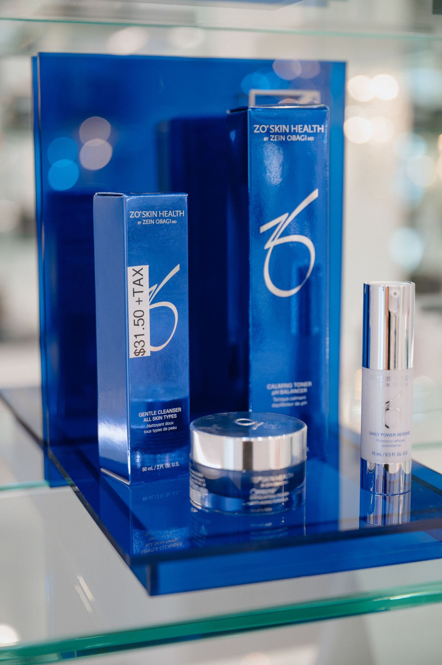 ZO Skin Health premium skincare collection displayed on blue illuminated shelf.