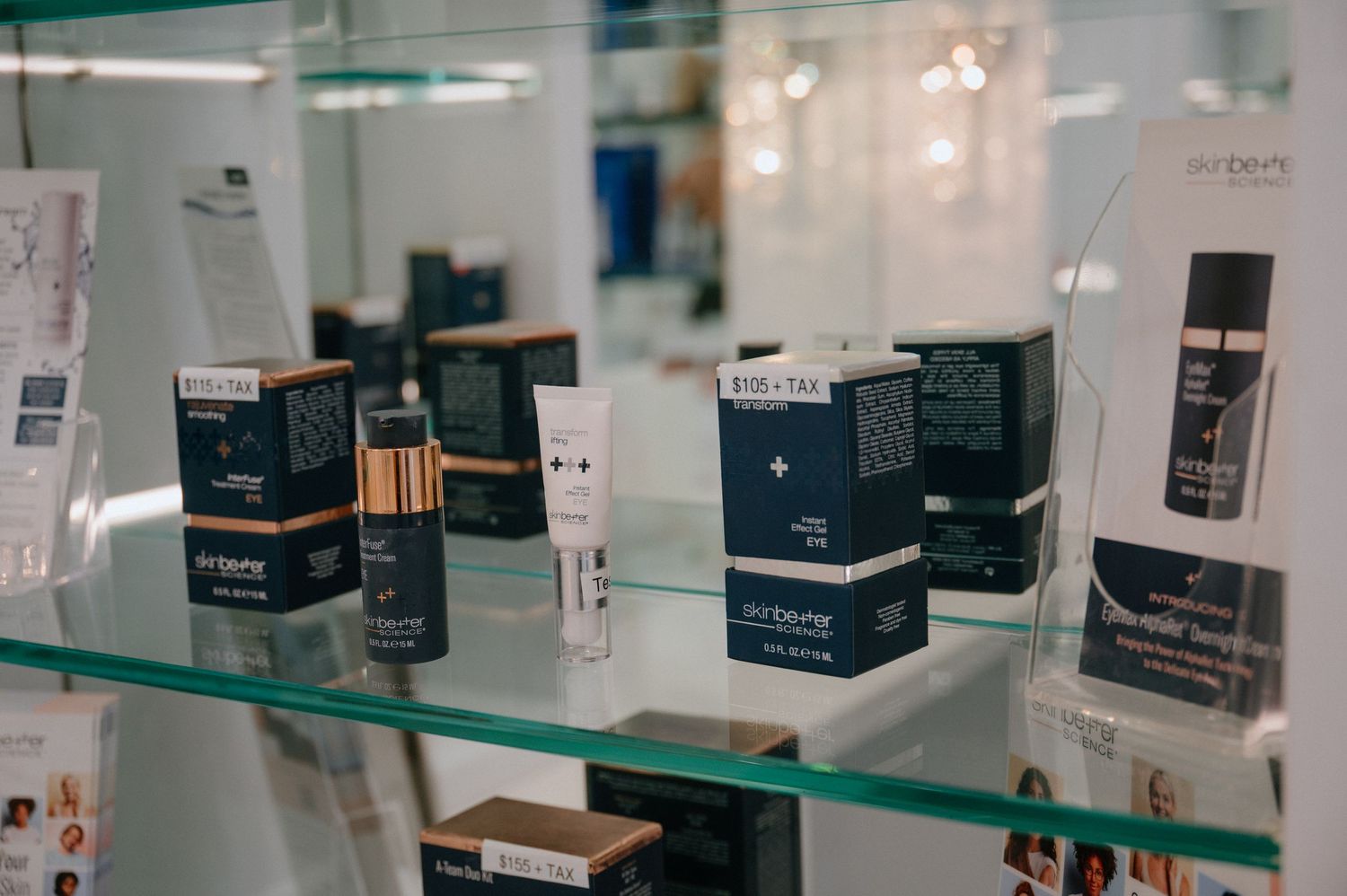 Professional skincare products and beauty treatments arranged on glass retail shelving.