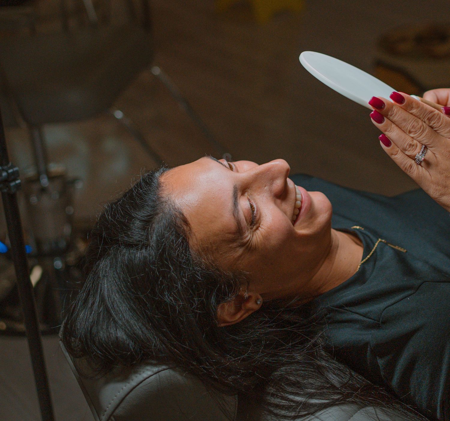 Spa client relaxing during beauty treatment with happy expression.