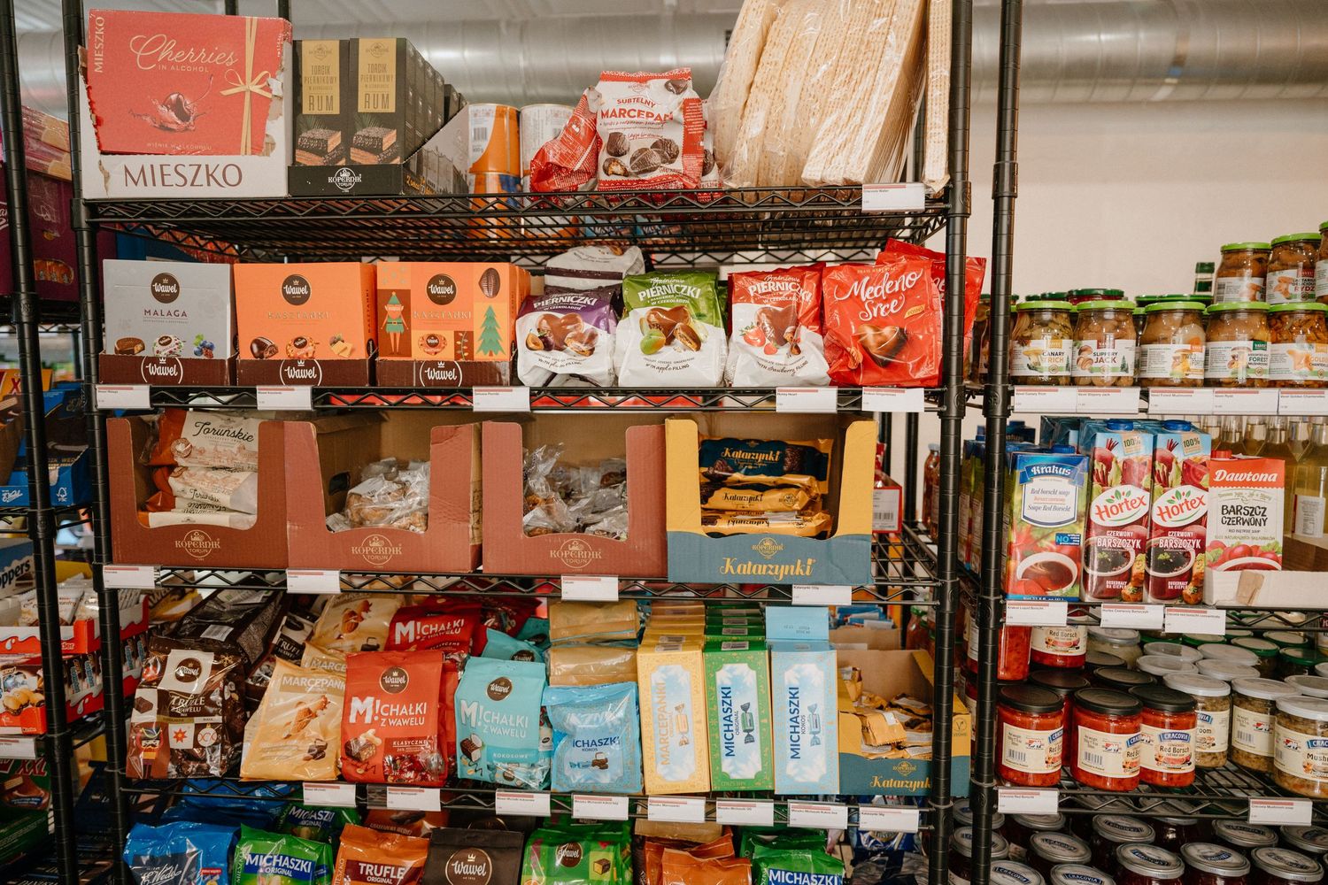 Organized retail shelves stocked with various packaged food products and snacks.