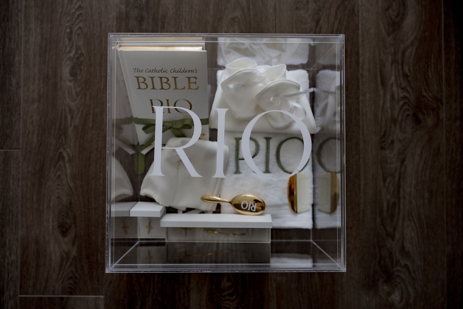 A white Bible and religious artifacts displayed in a clear display case.