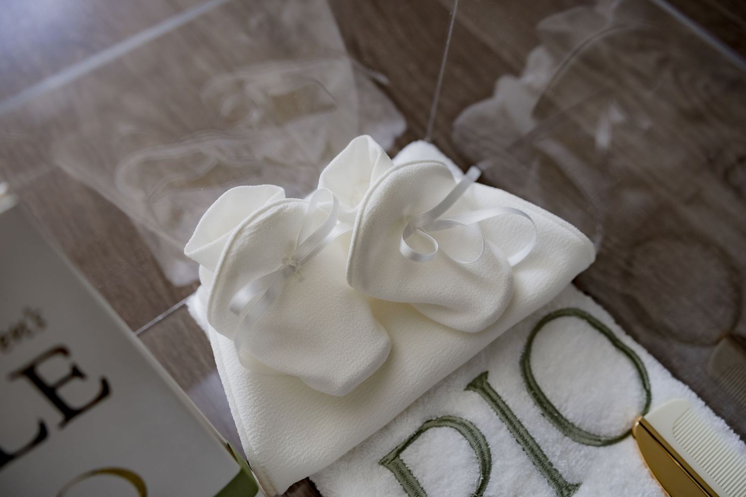 A close-up view of delicate white fabric details in a display case.