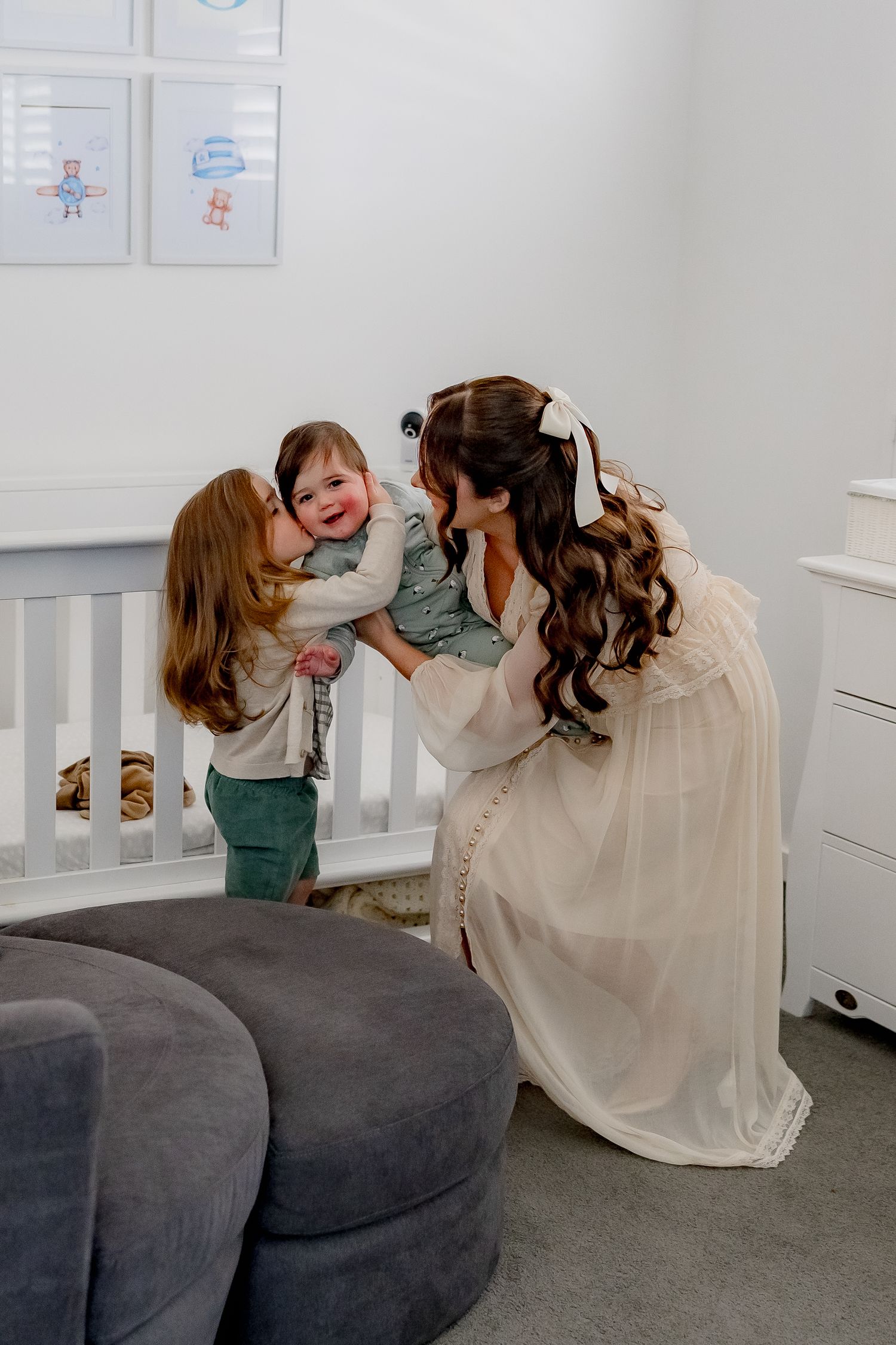 A tender moment shared in a modern nursery with gray and white decor.