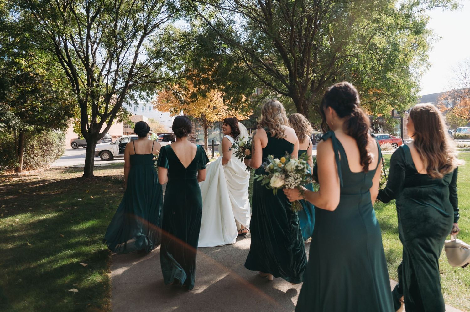 bride & bridesmaids walking outside BASH wedding venue in des moines iowa. des moines wedding photographer