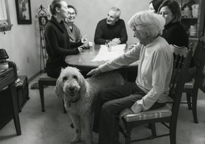 A series of black and white photographs showing people seated in various indoor settings.