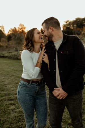 Candid moment of laughter and joy during golden hour photo session.