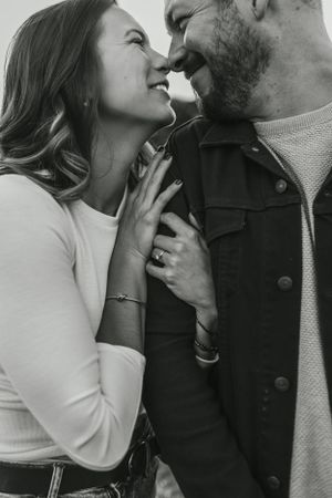 Close-up black and white portrait showing an intimate moment.