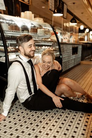 A happy couple sharing a candid moment at a vintage-style restaurant counter.