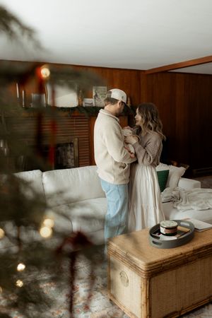 Artistic indoor photoshoot with soft lighting and wooden paneled walls creating a warm atmosphere.
