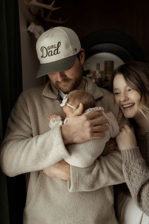 Intimate lifestyle photos showing tender moments between a couple in warm, neutral tones.