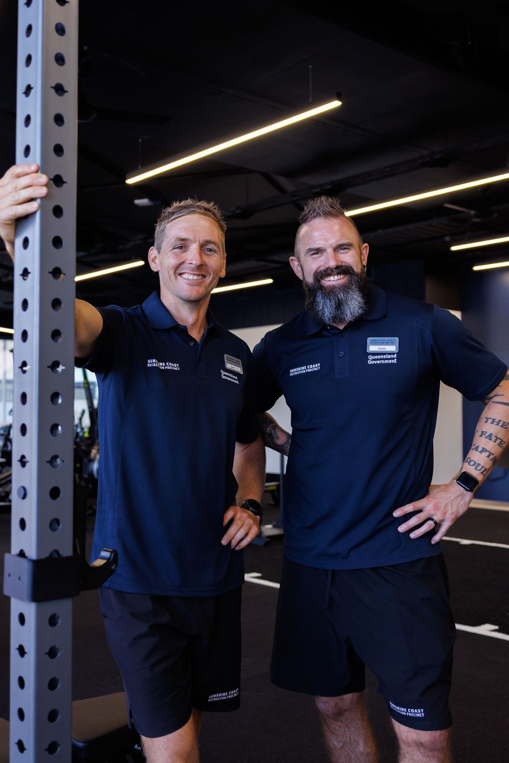 two gym staff members posing for commercial content photo shoot in their gym