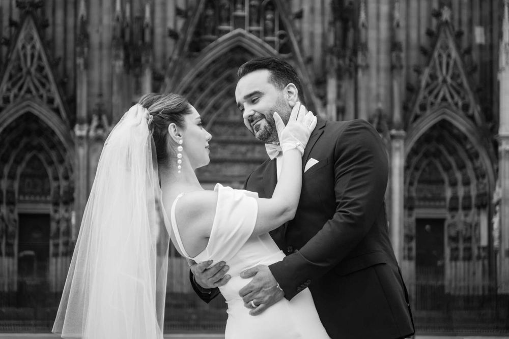 ein Paar in einem Hochzeit Fotoshooting vor Dom in Köln Stadt. ein Schwarz und weiß Foto in einem Trauung Fotoshooting.