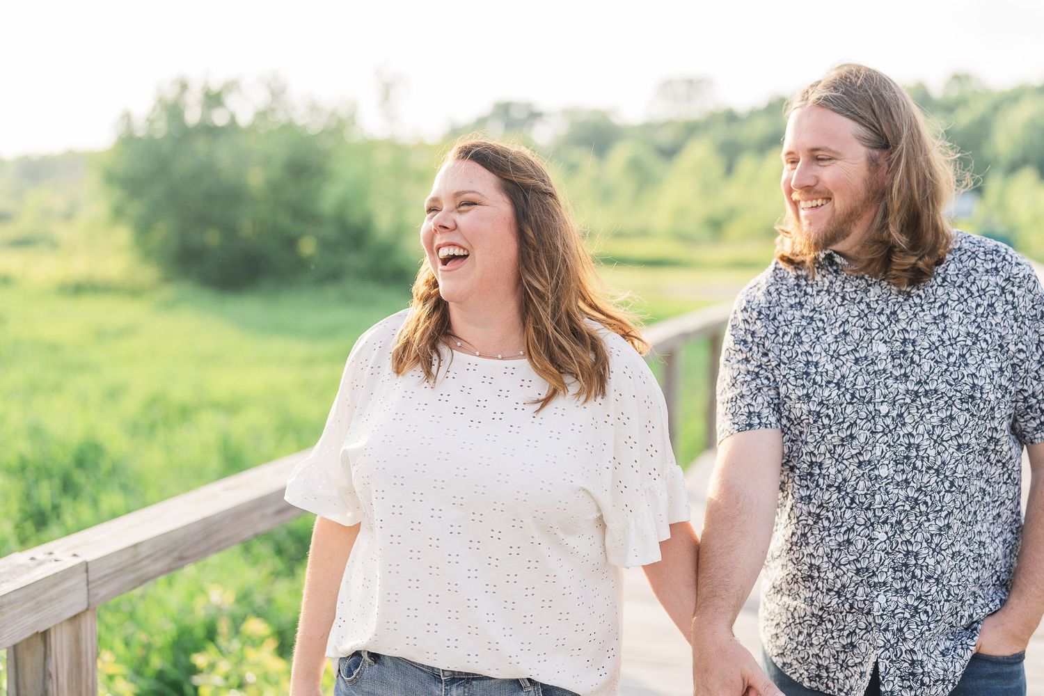 Engaged couple laughing and playfully interacting during their Kenosha engagement session.