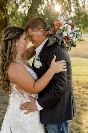 A romantic wedding couple shares intimate moments in a series of sunset photos with floral bouquet details.