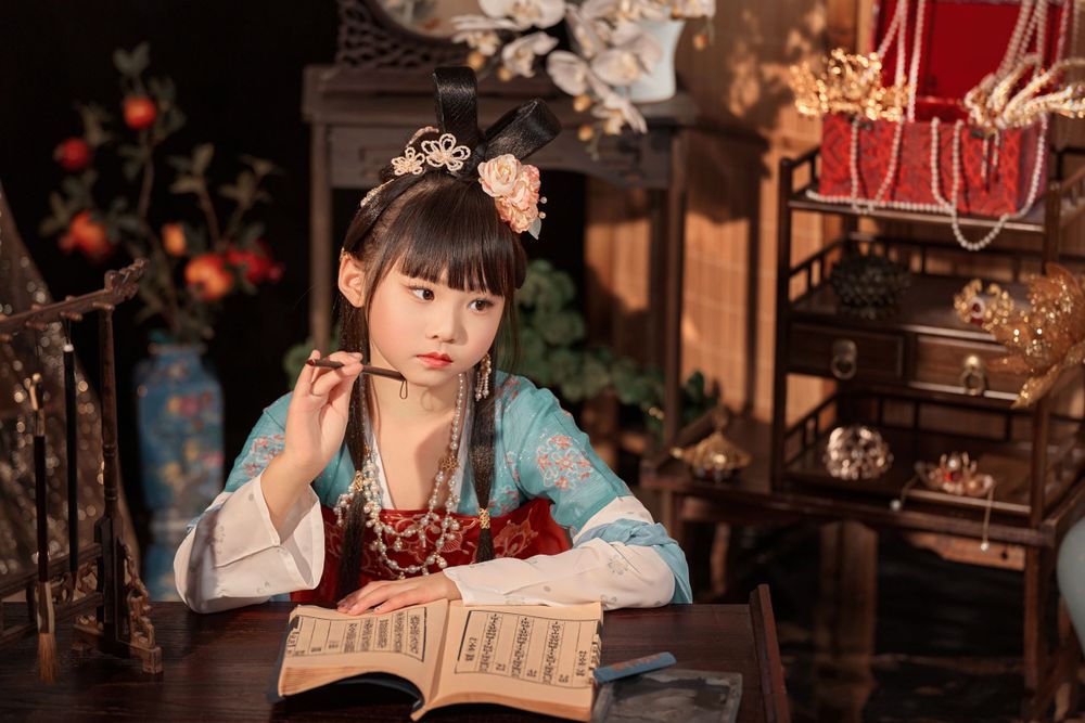 Cute children's studio portrait in an elegant Tang Dynasty Hanfu with dazzling golden props, by Imagine Image Studio.