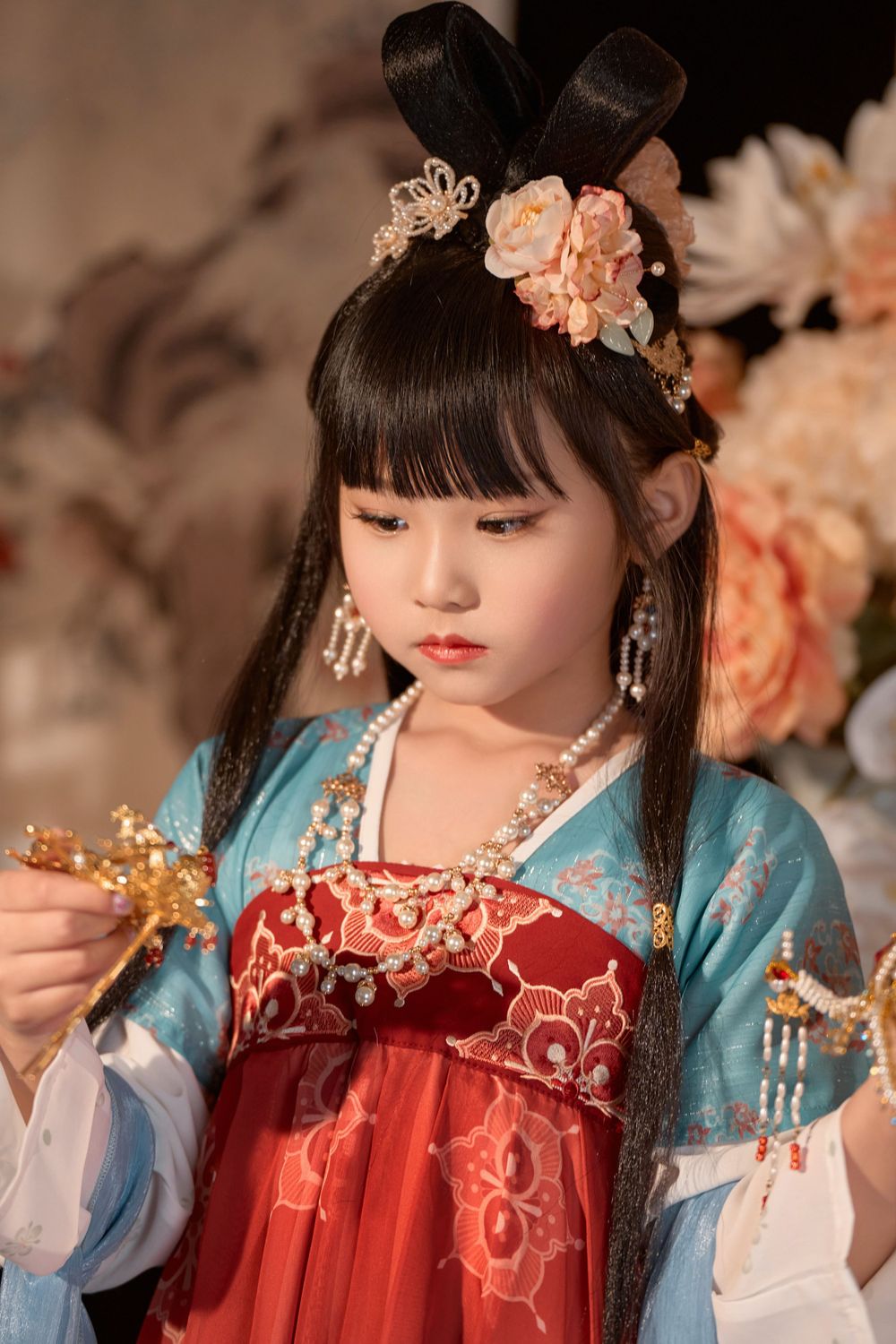 Cute children's studio portrait in an elegant Tang Dynasty Hanfu with dazzling golden props, by Imagine Image Studio.