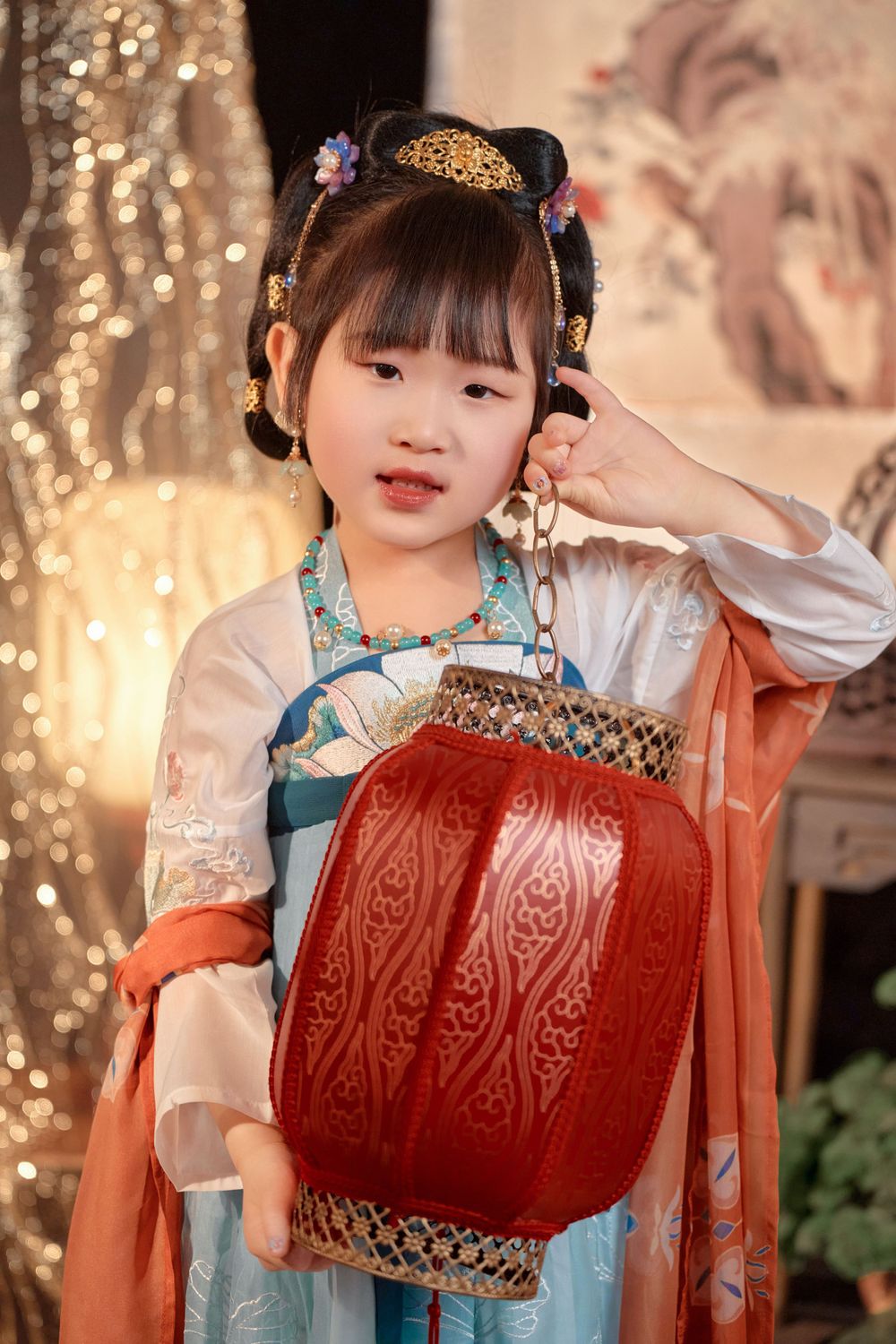 Magical kids Tang Dynasty Hanfu studio portrait featuring shiny golden props, by Auckland photographer Imagine Image Studio.