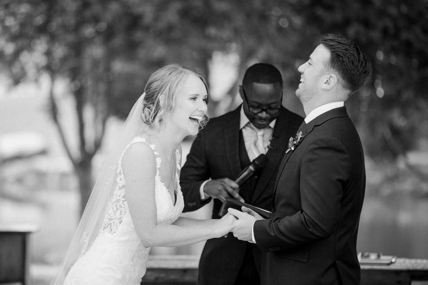A candid moment of a bride and groom exchanging vows at Carvers Cottage captured by Toronto Wedding Photographer.