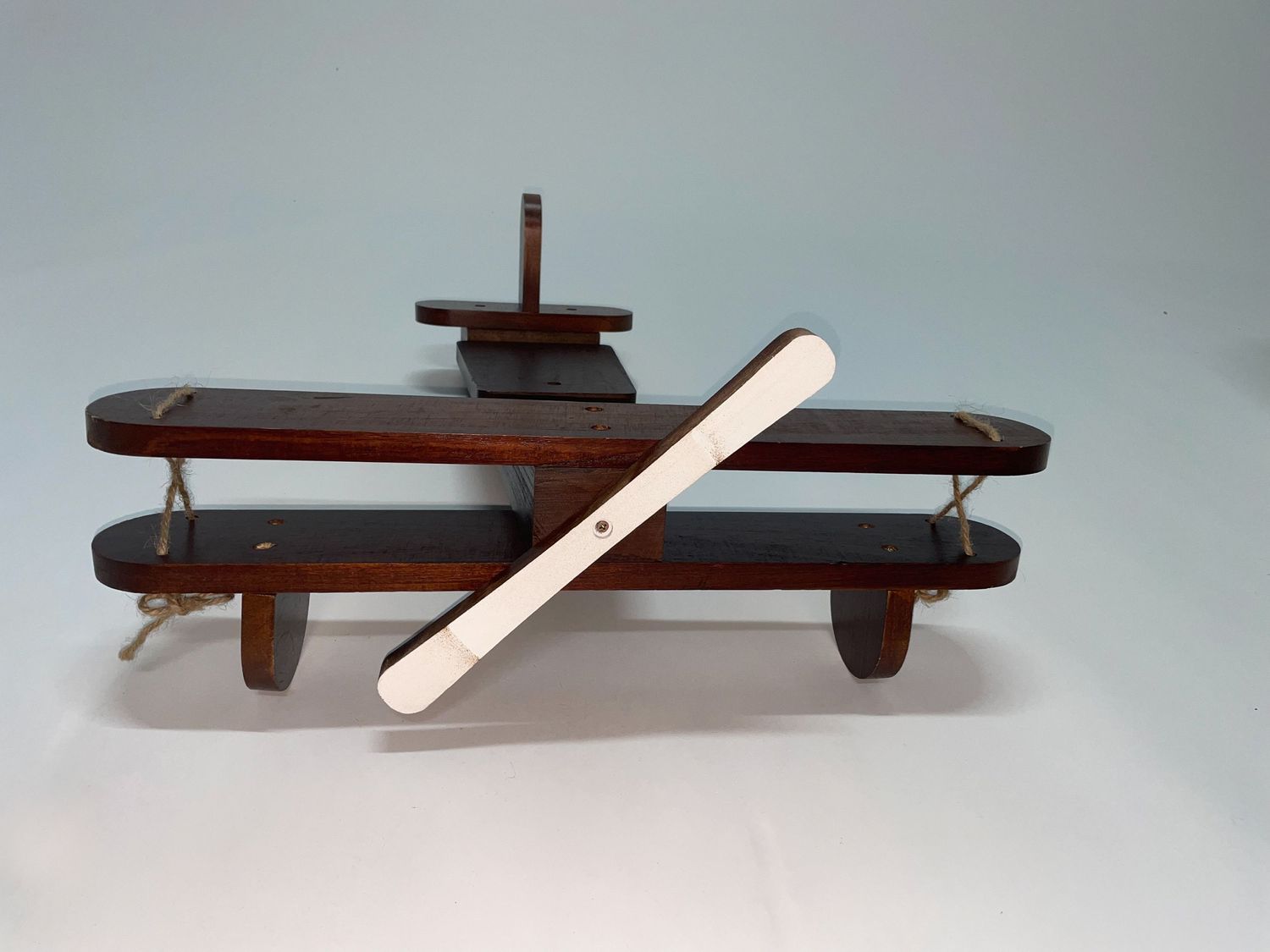 Wooden shelf or mounting bracket displayed from various angles against light background.