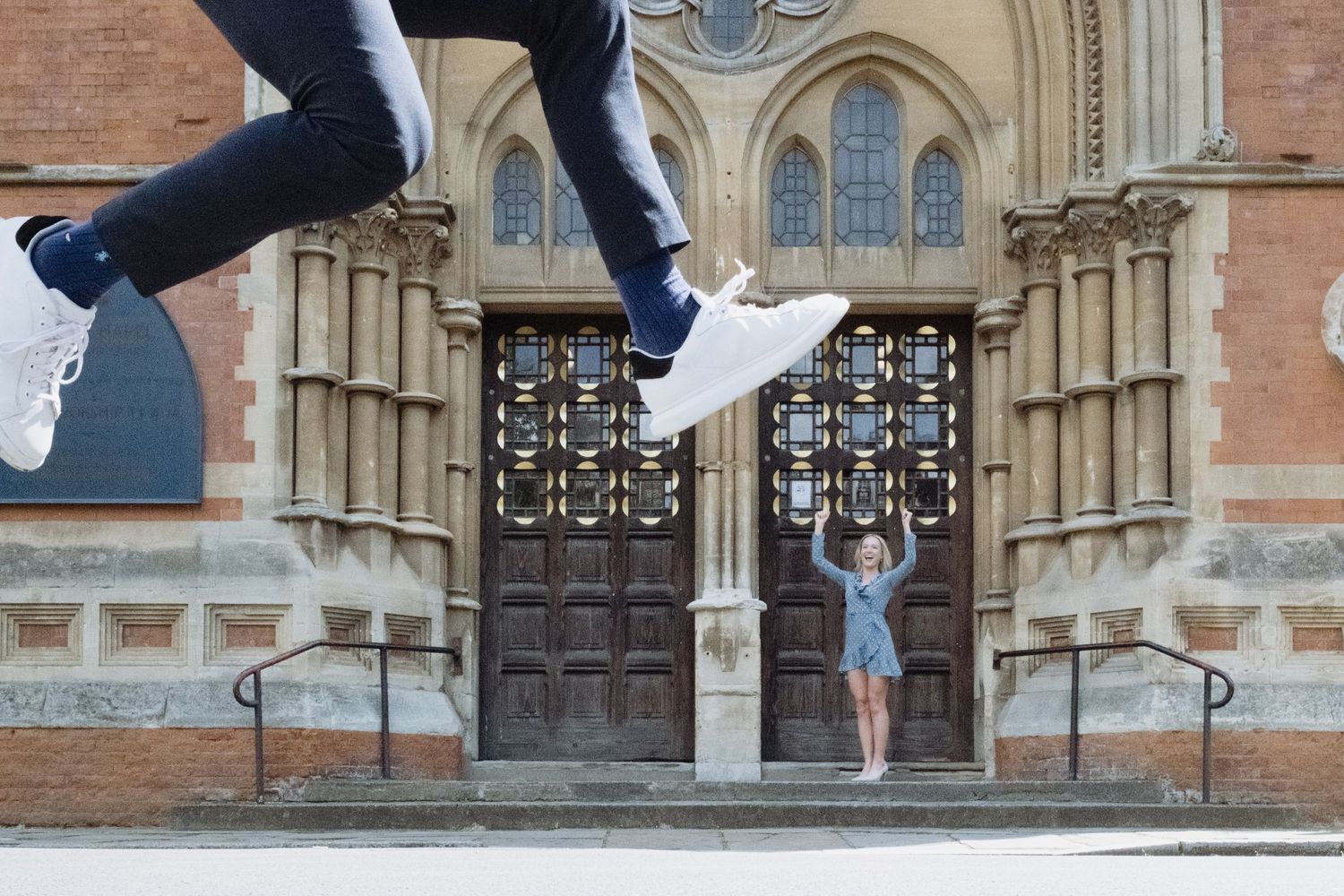 Woman in front of Registry Office in London cheering for her jumping fiance