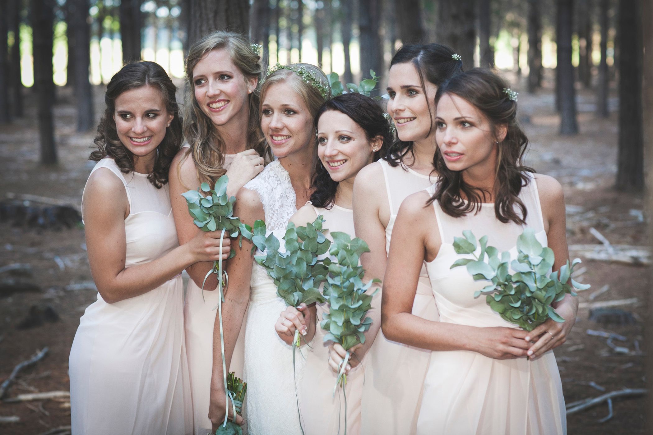 Beautiful bride Mel, with her bridesmaids in Tokai Forest, after marrying her love, Gert at Blue Bird in Muizenberg, CT
